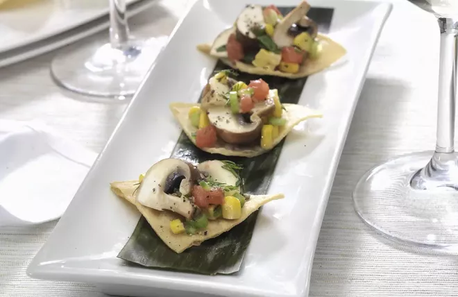 Crimini mushroom ceviche on 3 tortillas served on a white plate