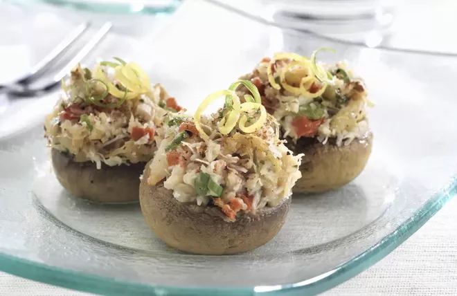 3 cajan seafood stuffed mushrooms on a white plate