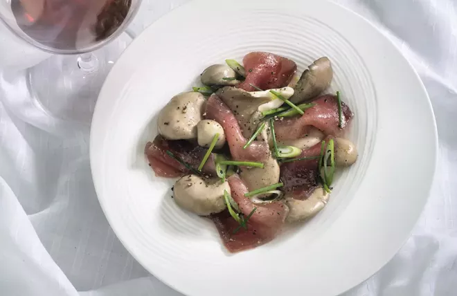 Cured Tuna with Oyster Mushrooms and Green Onion on a White Plate