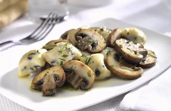 Crimini Mushrooms with Olive Gnocchi on a white plate
