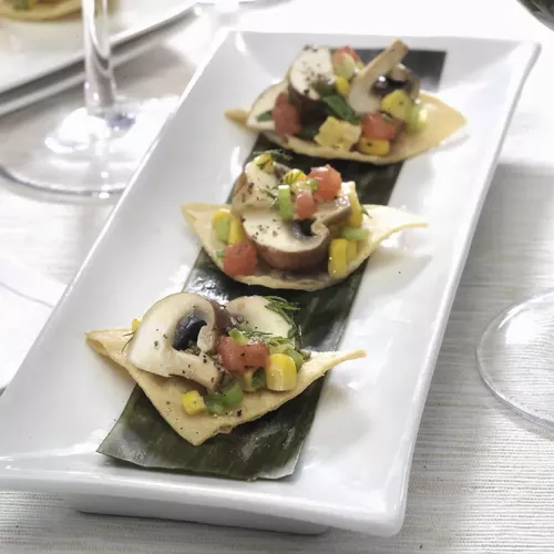 Crimini mushroom ceviche on 3 tortillas served on a white plate