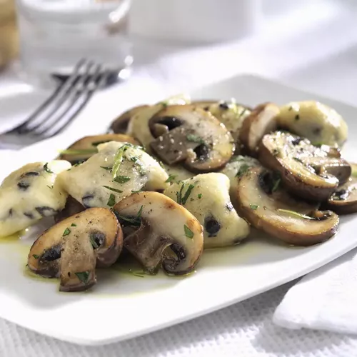 Crimini Mushrooms with Olive Gnocchi on a white plate