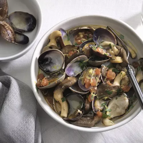 Manila Clams and Oyster Mushrooms in a white bowl